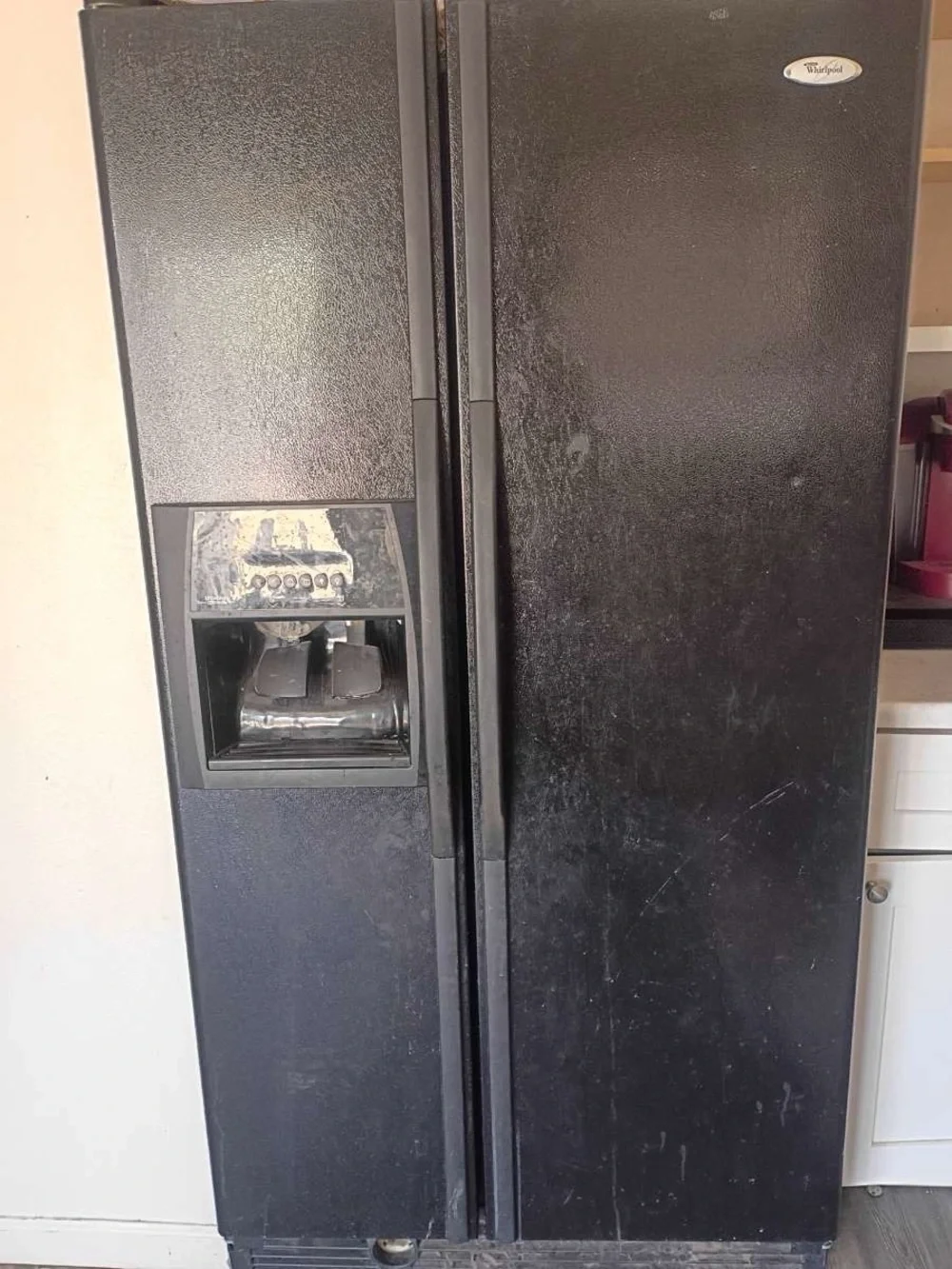 Black Side-by-Side Refrigerator with Ice & Water Dispenser. Cleaned